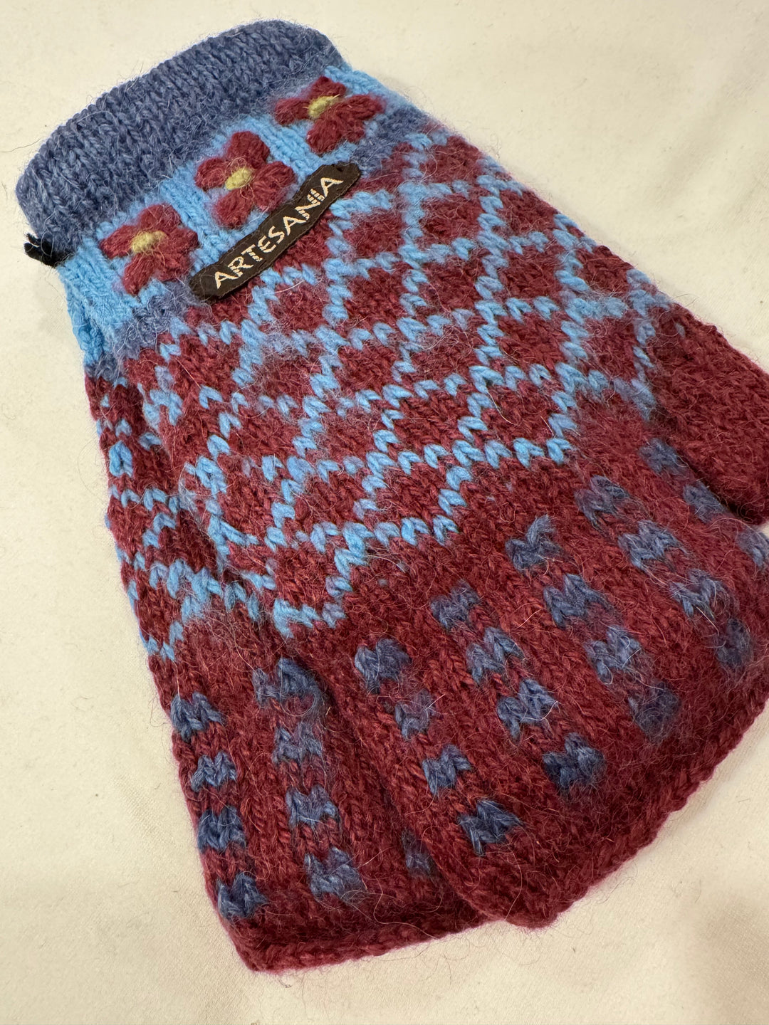 Burgundy Blooms alpaca fingerless gloves with hand-embroidered burgundy flowers on a pale sky blue band