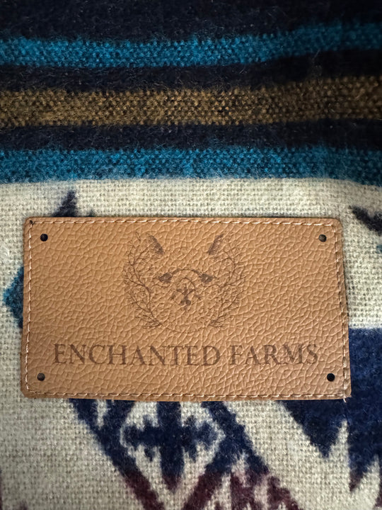 Leather Enchanted Farms tag sewn onto the Cuzco Plaza de Armas Alpaca Wool Blanket.