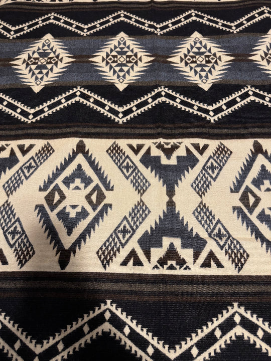 Close-up of the Cuzco Stone Alpaca Wool Blanket showing its soft alpaca fibers and intricate weave.
