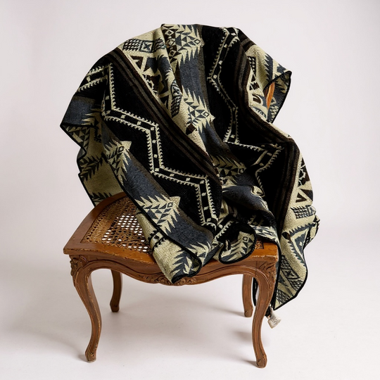Cuzco Stone Alpaca Wool Blanket draped over a vintage wooden chair — soft artisan alpaca textile from Enchanted Farms
