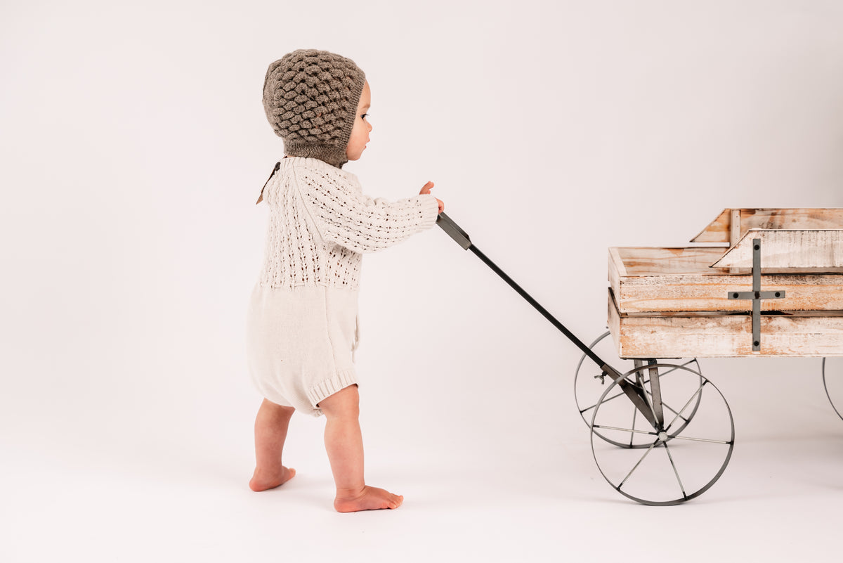 Child's alpaca bonnet hat that fastens with buttons under the chin, in soft undyed alpaca, sized for infants and toddlers