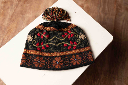 Mariana alpaca hat in amber with a hand-knit fern pattern, made in Peru