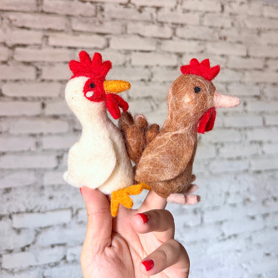 Chicken needle felted wool finger puppets worn on a hand