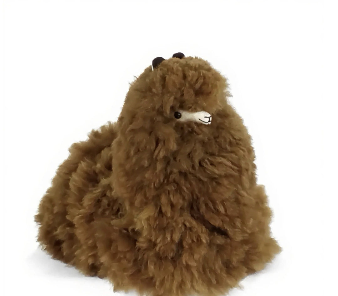 12 inch brown alpaca fleece stuffed animal sitting in the cushing pose